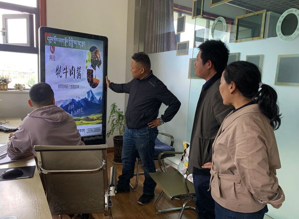 为拉萨市气象局工作人员向企业征集移动互联网购物二维码进行二次设计，植入到LED智慧显示屏。摄影：德吉央宗.jpg